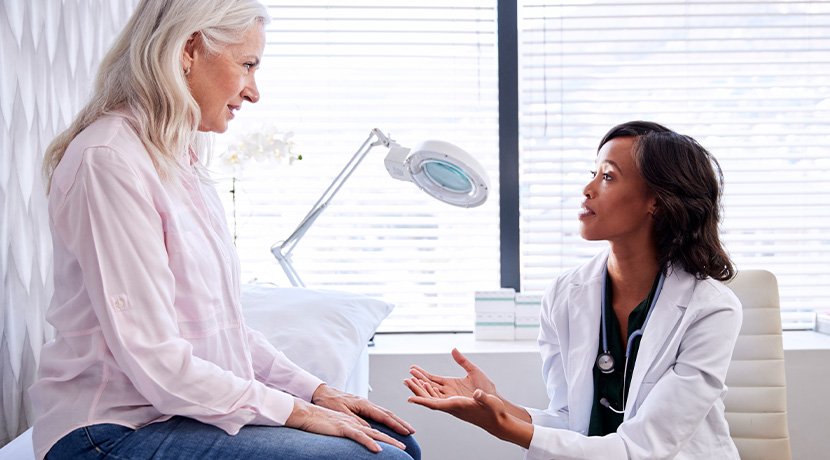doctor talking to a patient about cardiology and family risk of heart disease