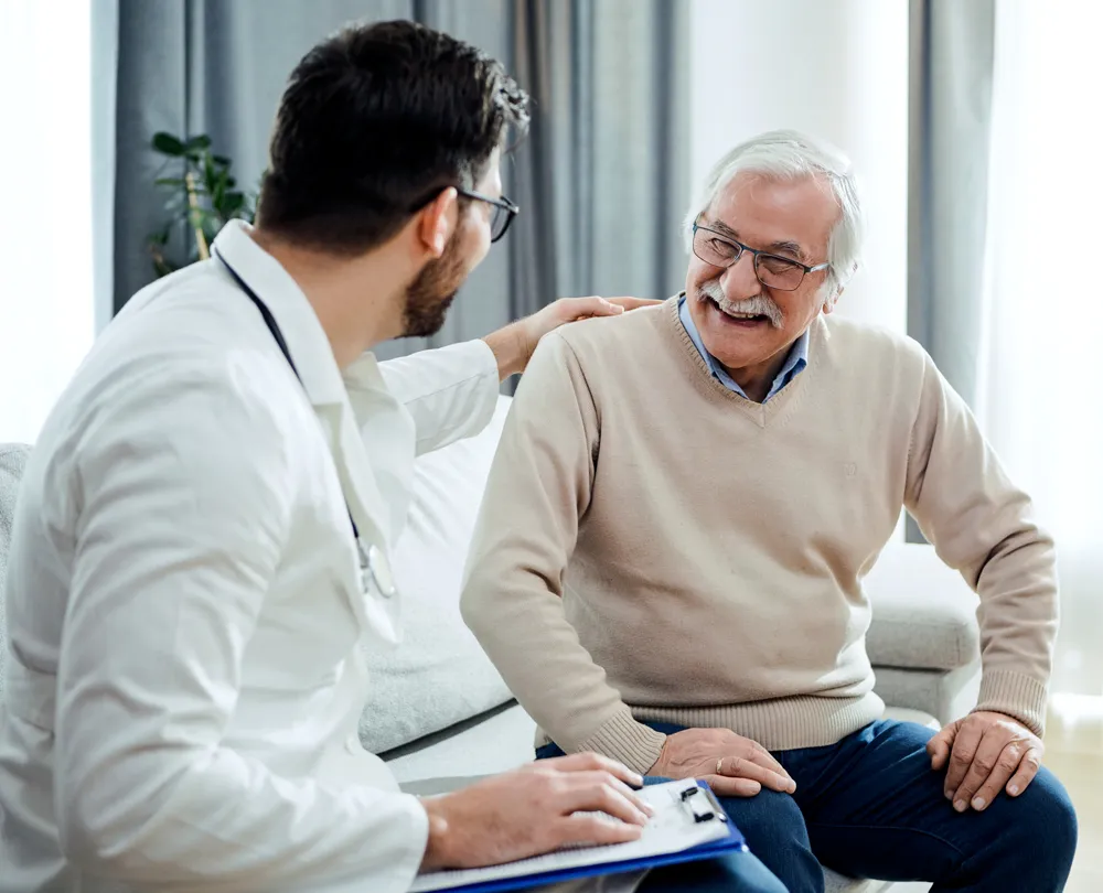 cardiovascular doctor sitting with patient to talk during in-office visit